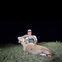 Hunter with a Nubian Ibex taken at BarBell Ranch in Sweetwater, TX, under a clear night sky.